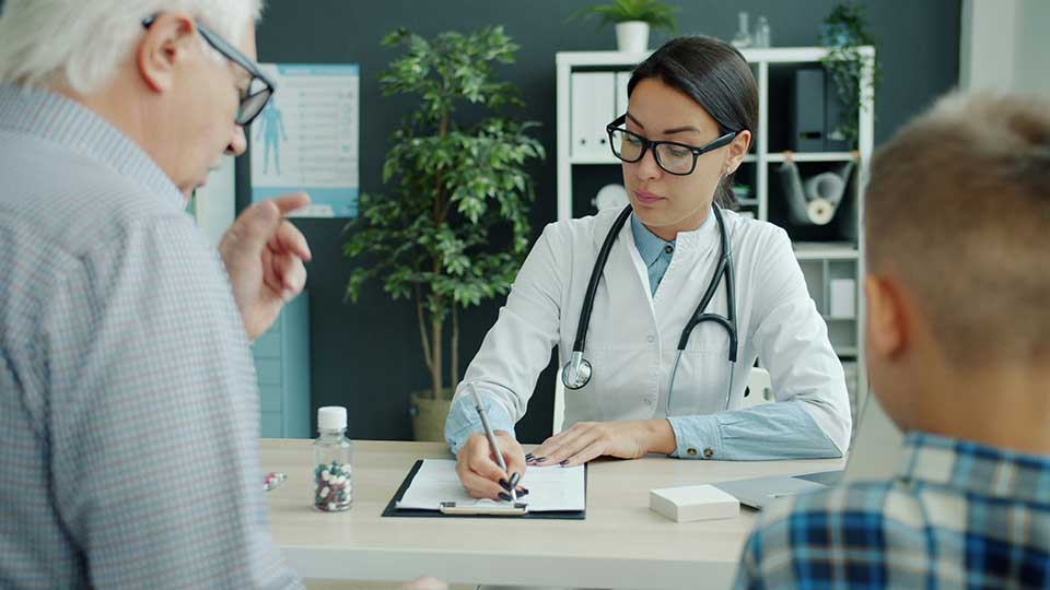 Doctor consulting a patient on how to register with a GP